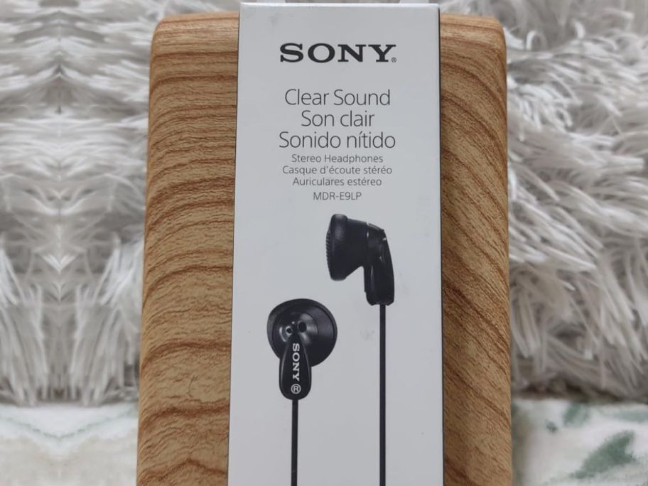 A box of Sony Earbuds on a wooden stand