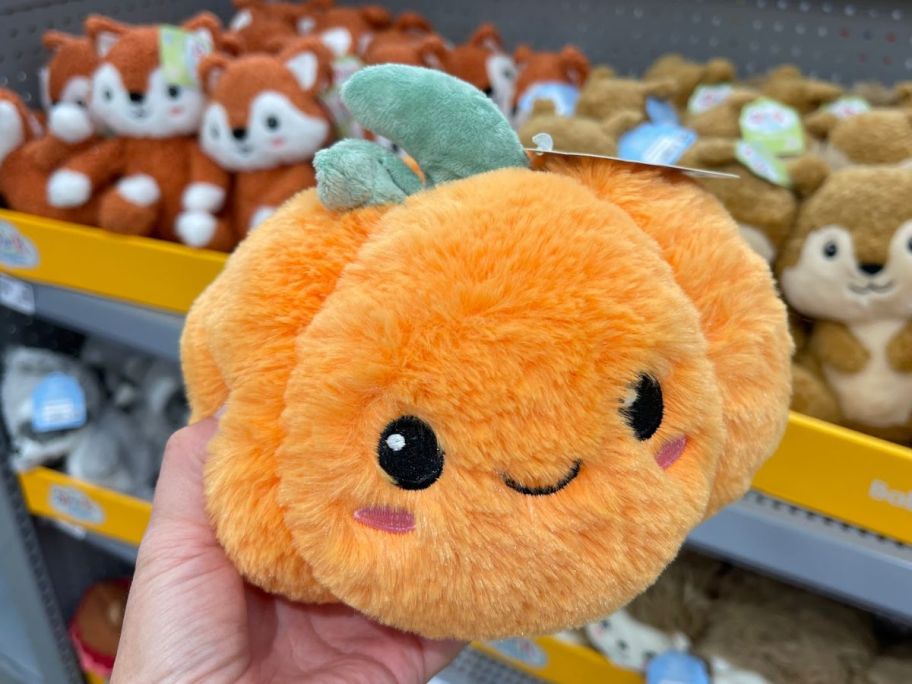 hand holding Spark.Create.Imagine Pumpkin Plush Toy