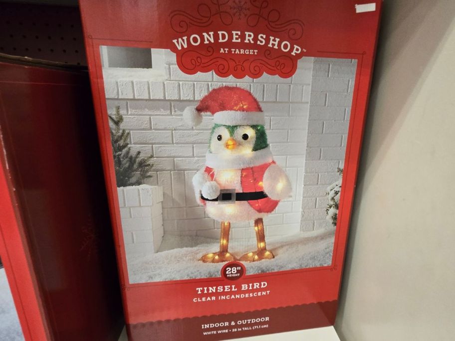 A box with a Wondershop Christmas Incandescent Tinsel Santa Bird