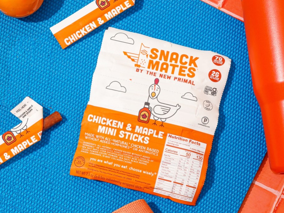 pack of The New Primal Chicken & Maple Mini Sticks on a blue yoga mat
