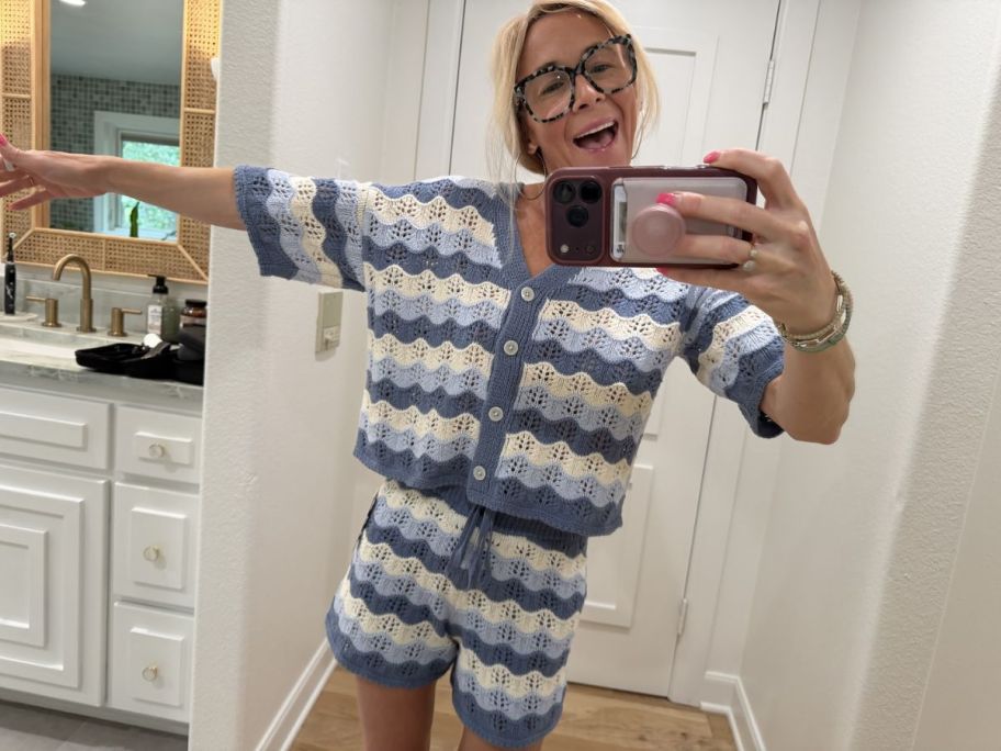 Woman taking a picture of herself wearing a Universal Thread Cardigan Sweater and Shorts