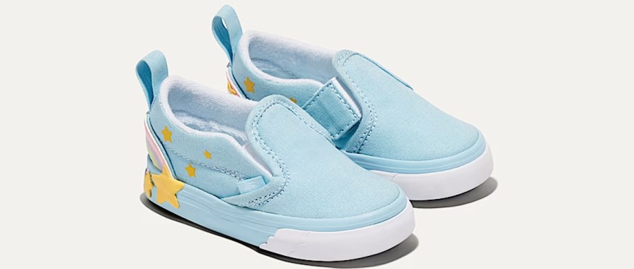 pair of blue slip on sneakers with yellow stars at the back