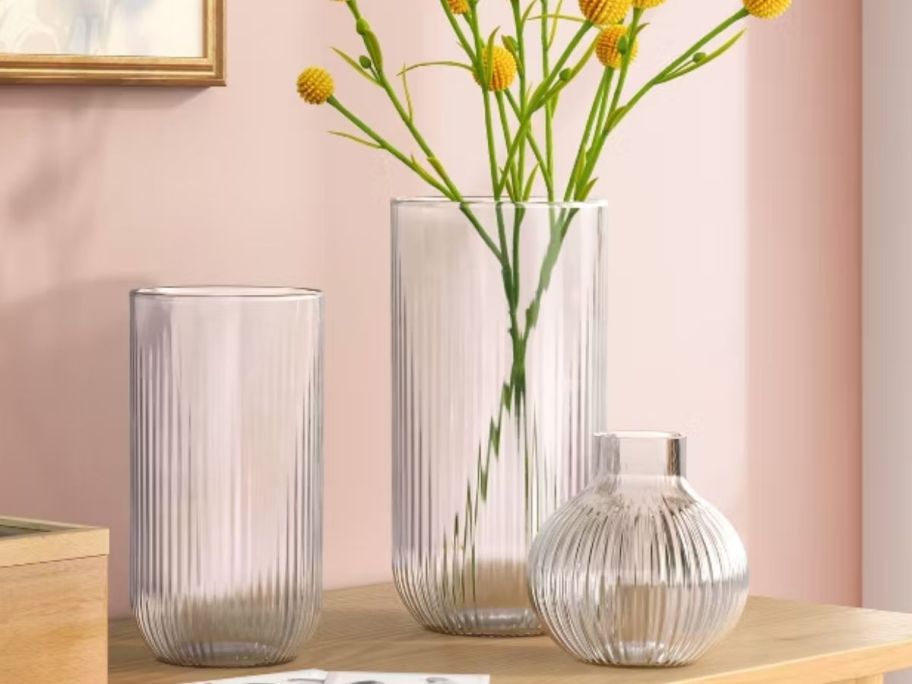 three different vase with flowers inside 