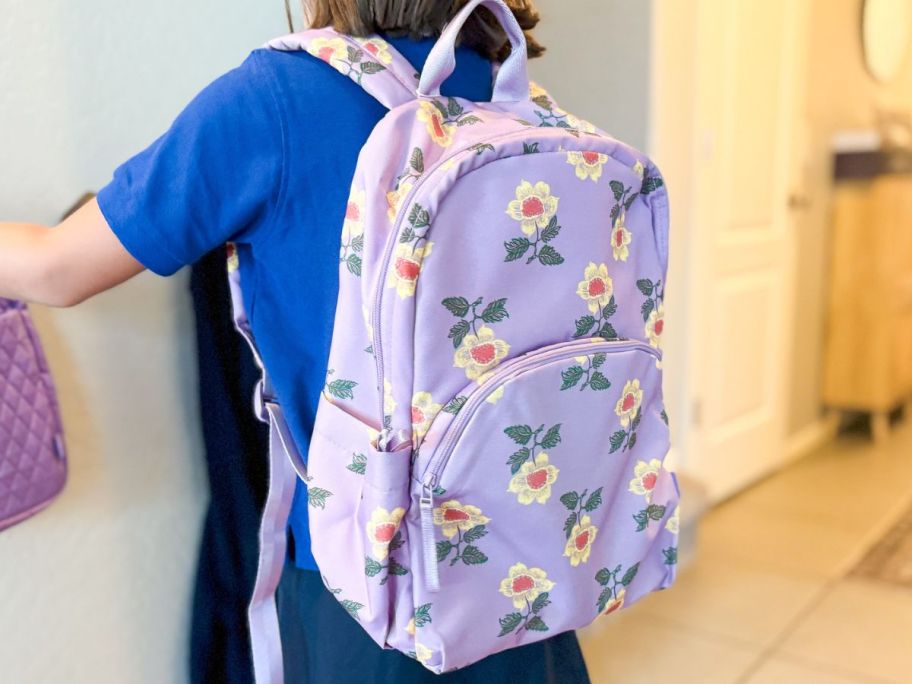 Girl wearing a floral vera bradley backpack