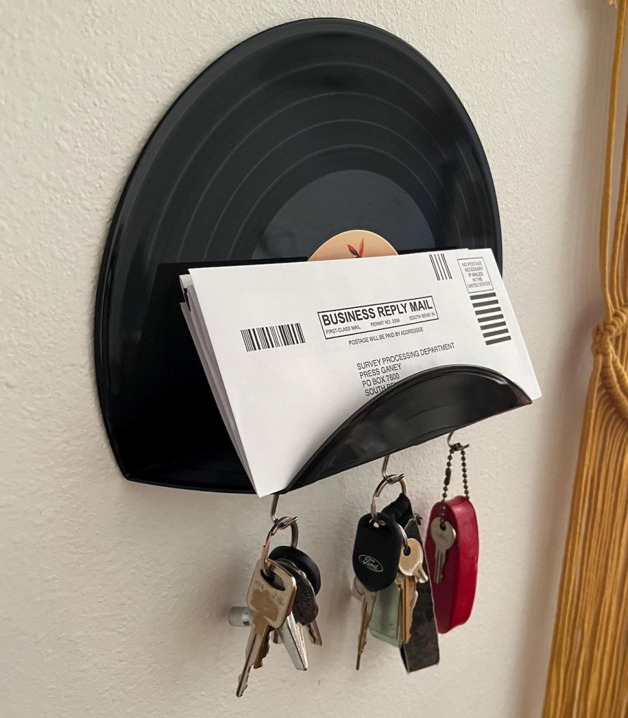 vinyl record shelf with keys on wall