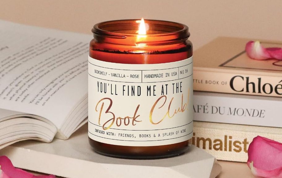 you'll find me at the book club candle lit on counter with pile of books