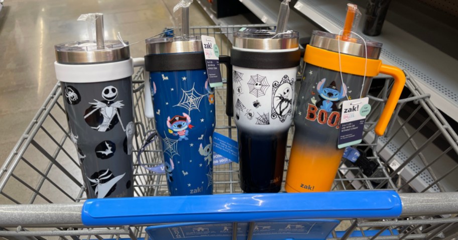 Four different Halloween themed tumblers inside basket of Walmart cart