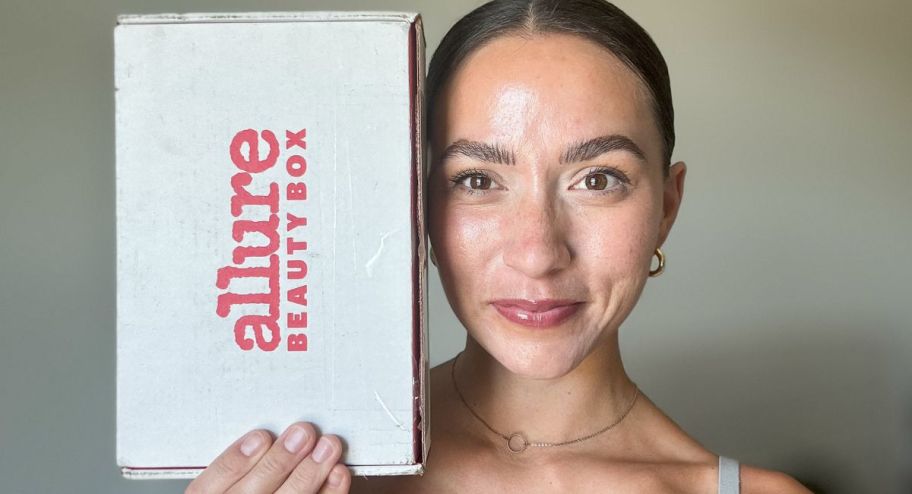 woman holding allure bo nrext to her face