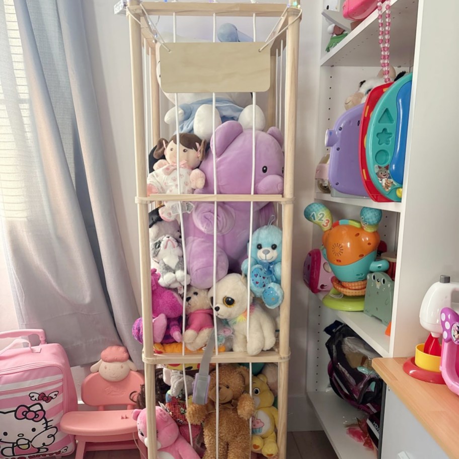 wooden stuffed animal storage container full of toys