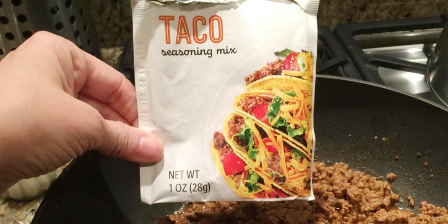 hand holding packet of taco seasoning