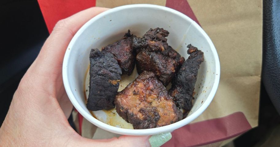 arby's steak bites in cup in hand