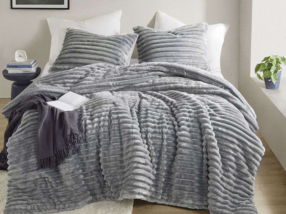 grey comforter and shams on bed