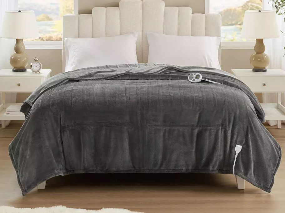 grey heated blanket on bed
