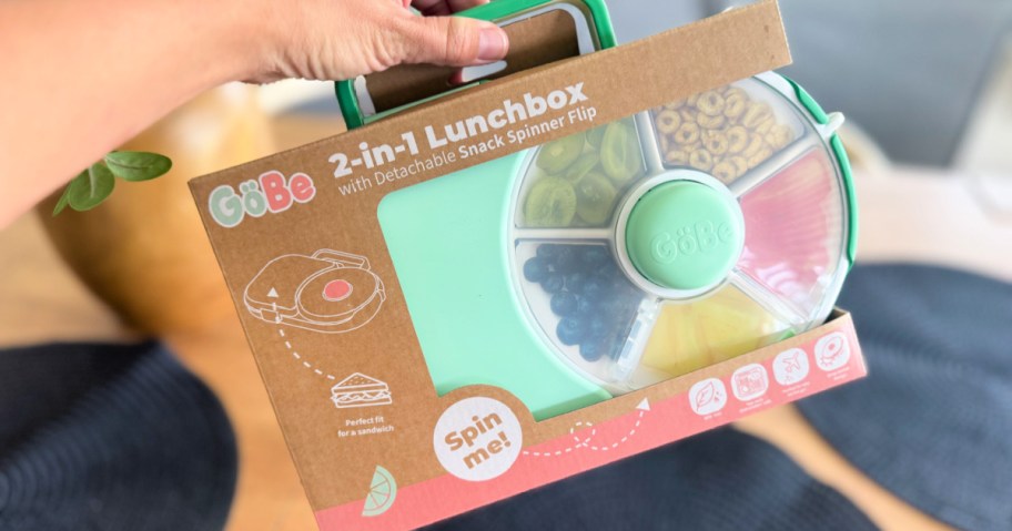 hand holding a kid's lunchbox with spinner