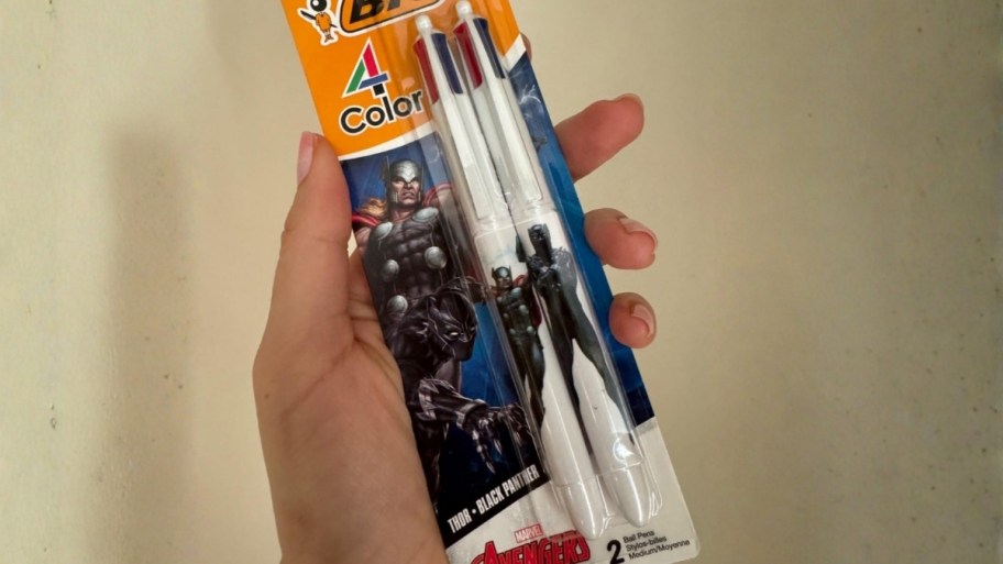 a womans hand holding a 2 pack of bic 4 colors pens