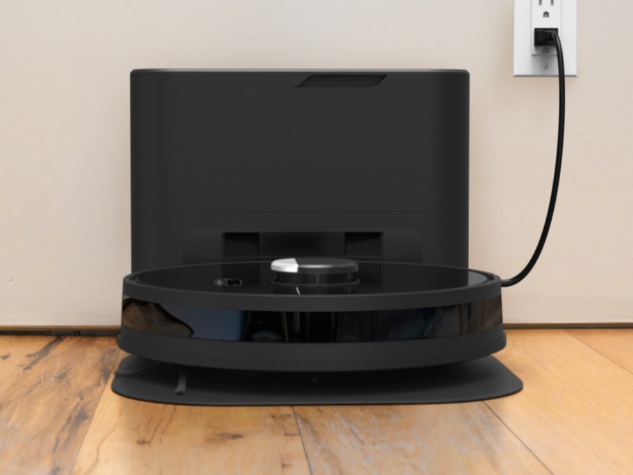 black vacuum with dock on wood floor