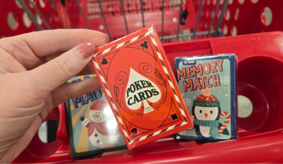 a womans hand holding a deck of playing of cards