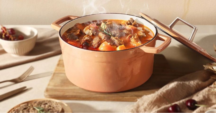 brown Carote Cast Iron Dutch Oven on table with stew in it