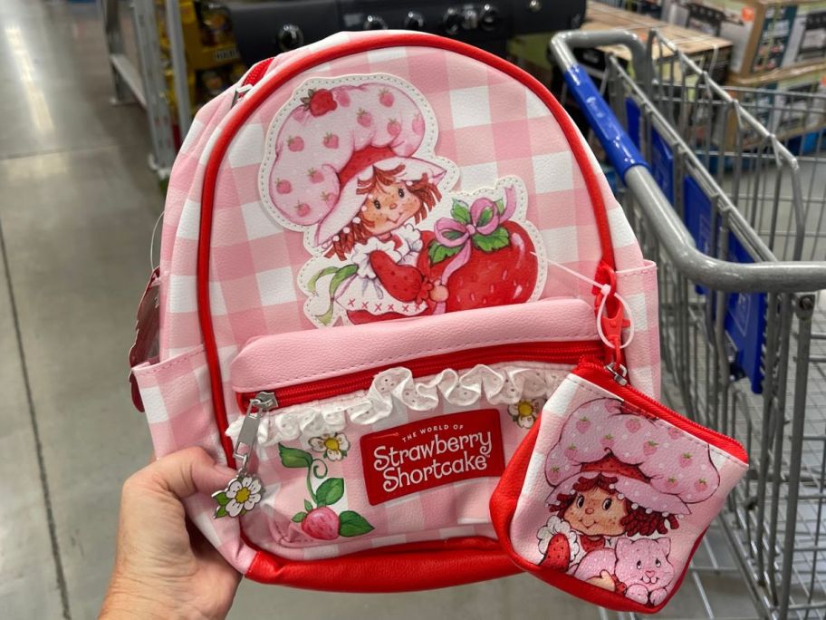 character mini backpacks in strawberry shortcake in womans hand at the store