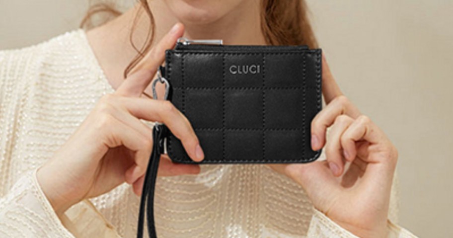woman holding a black wallet