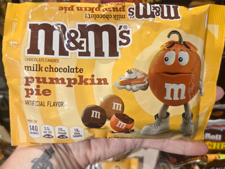 hand holding m&m's bag 