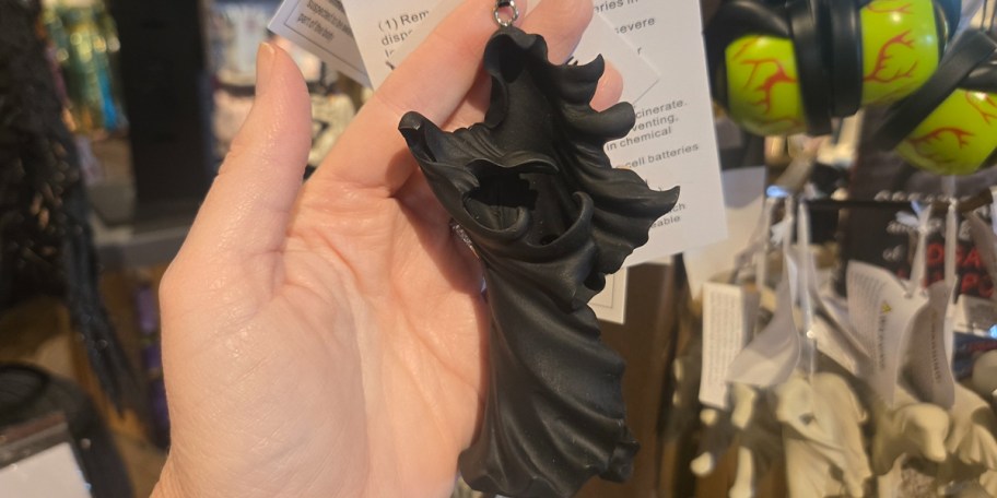 hand holding black ornament 