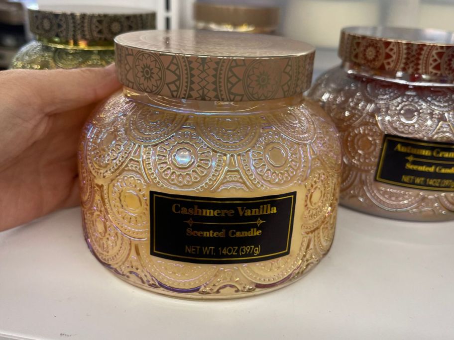 hand holding jar candle in store