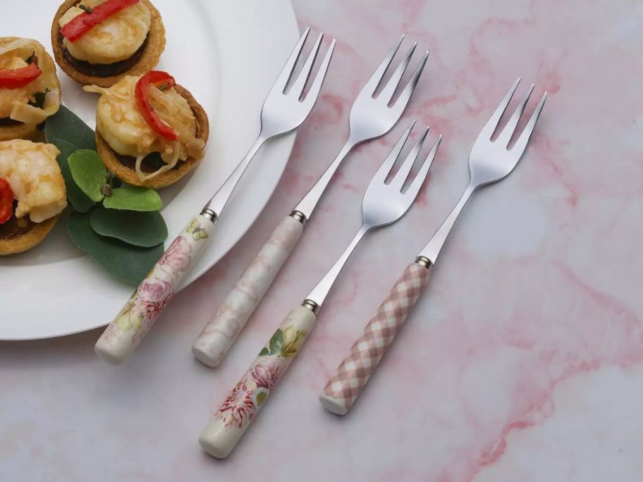 Dolly Parton 4-Piece Appetizer Fork Set on table next to plate