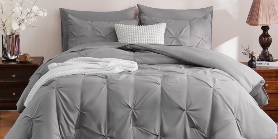 gray comforter set on bed