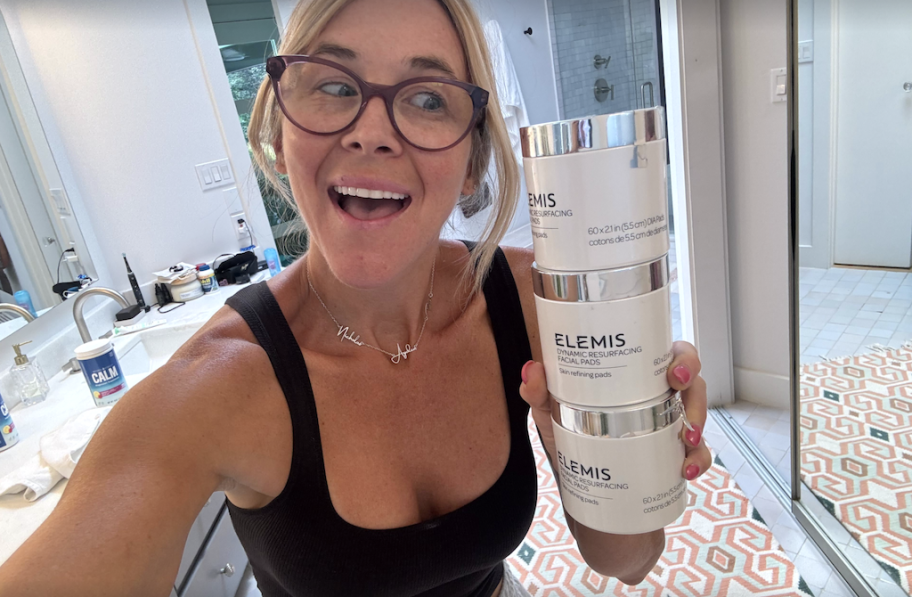 woman holding 3 jars of Elemis resurfacing pads