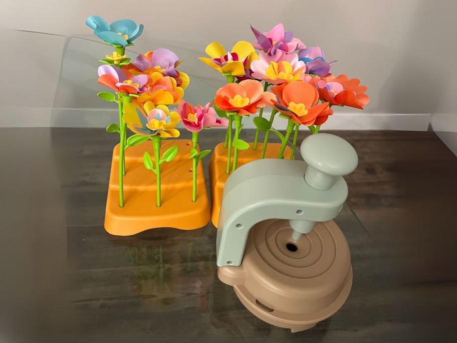 fabric flower stems in holder next to embosser