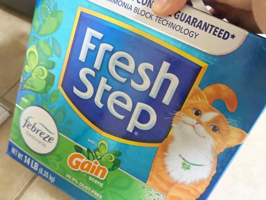 hand reaching for box of fresh step cat litter