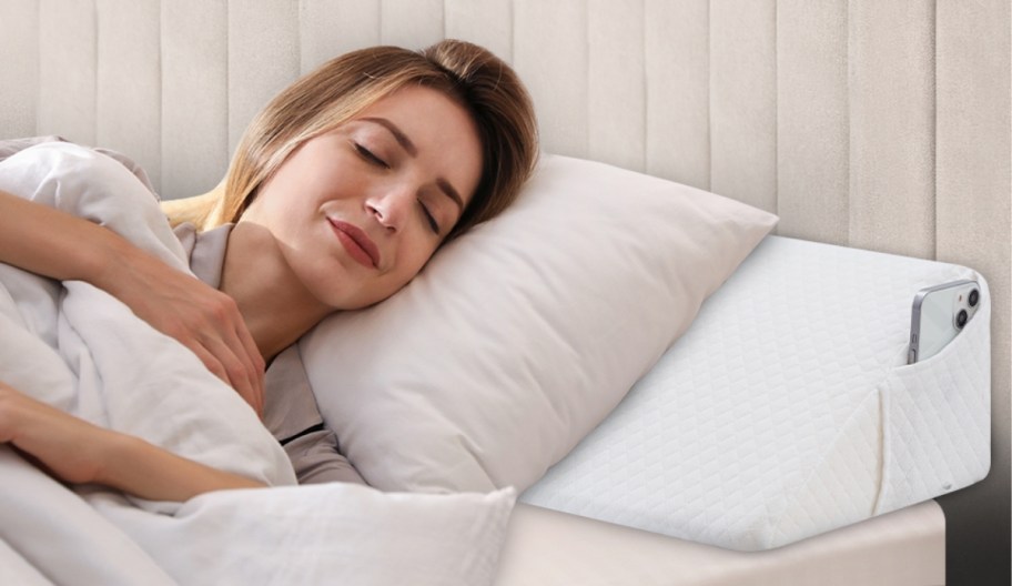 woman sleeping on pillow supported by wedge pillow