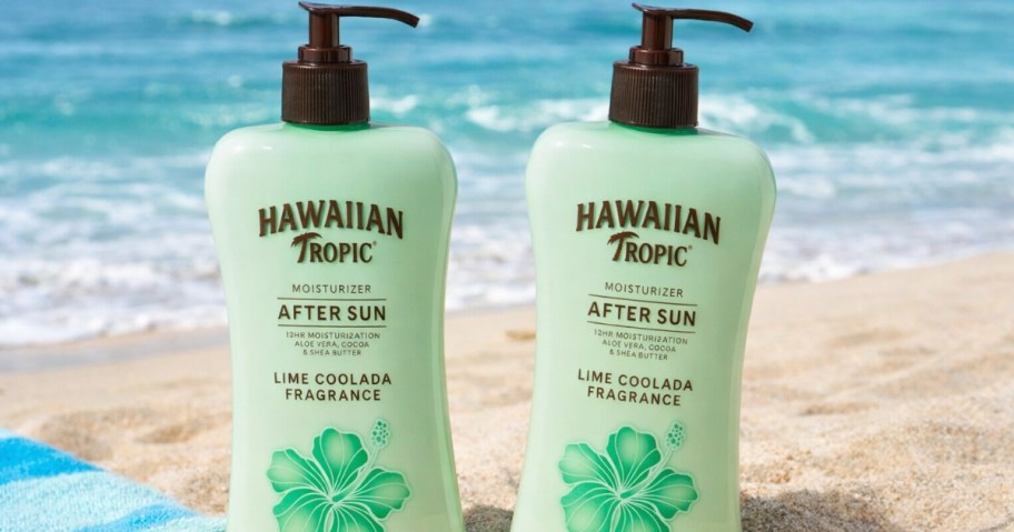 two bottles of Hawaiian Tropic after sun lotion on a beach