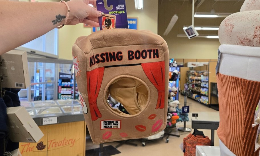 a woman's hand holding a kissing booth pet costume
