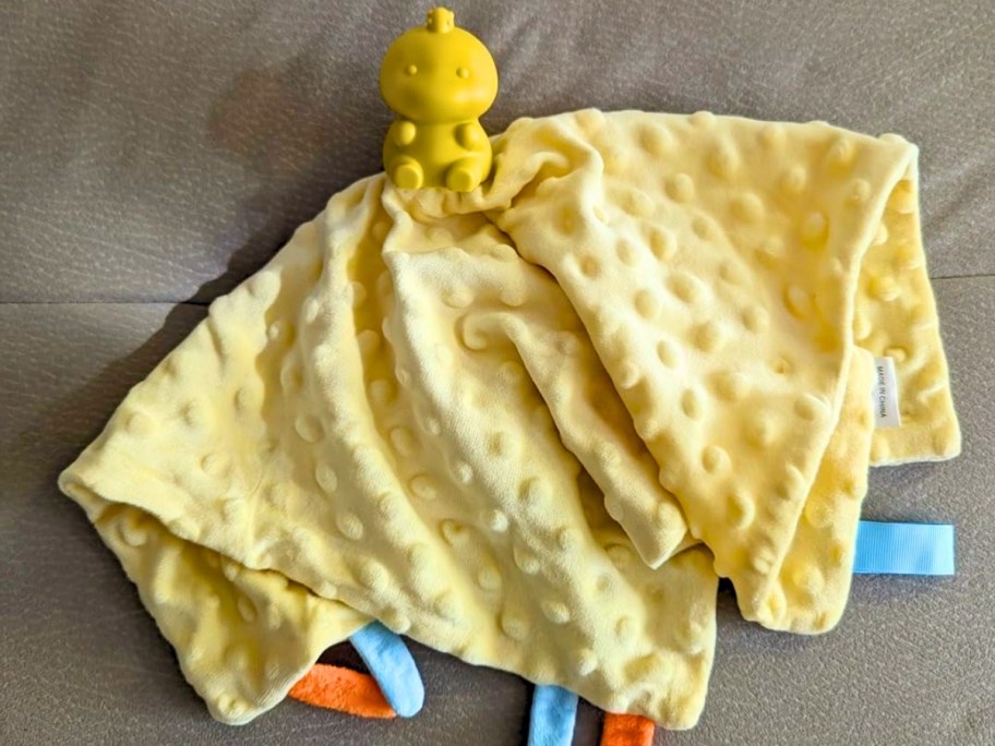 a yellow dinosaur snuggle toy