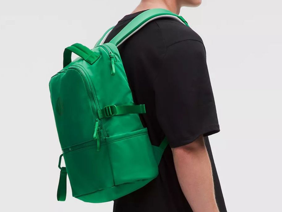 A man wearing a green backpack