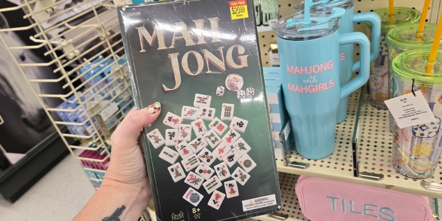 hand holding green mahjong game box 