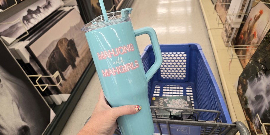 hand holding blue mahjong tumbler