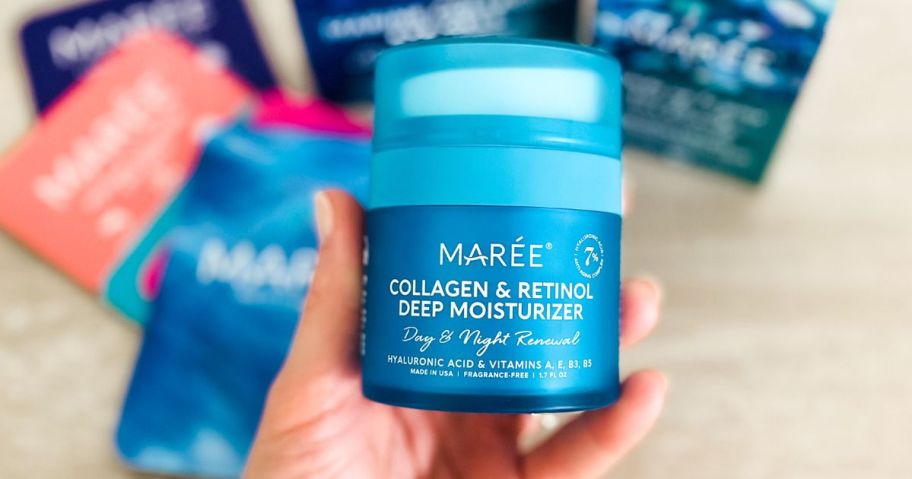 hand holding Maree Face Moisturizer Retinol Cream for Face jar in hand