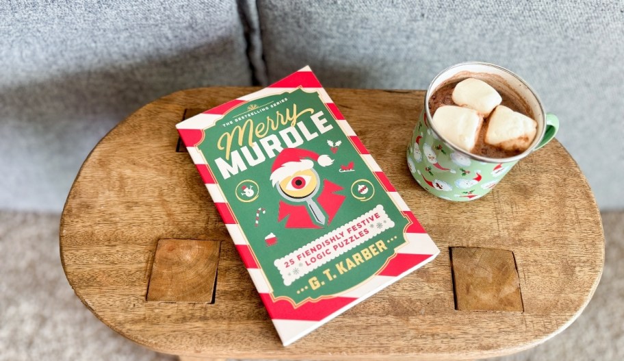 a murdle book is a woman's lap as shes holding a cup of hot cocoa