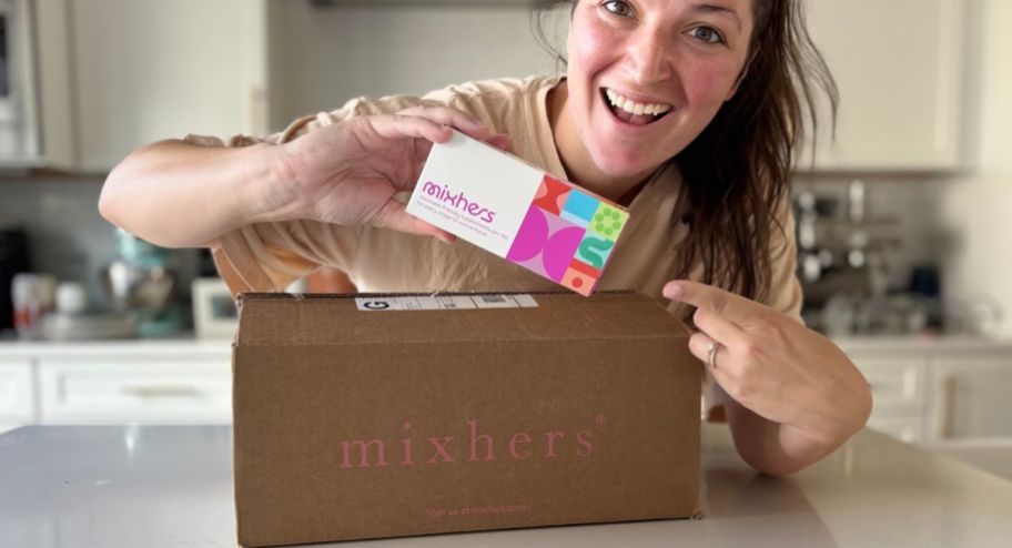 woman showing her mixhers sample box on top of her mail box
