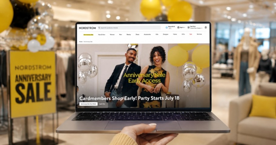 hand holding laptop with nordstrom anniversary sale on screen in store