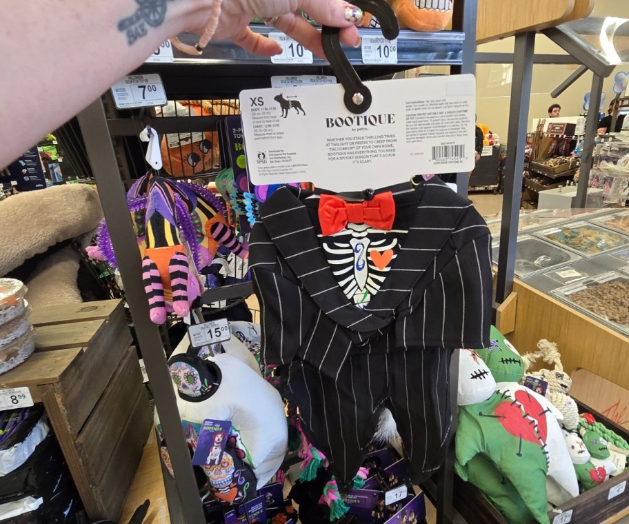a womans hand holding up a day of the dead pet halloween costume