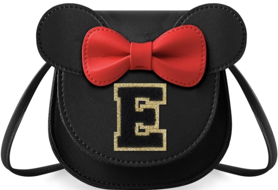 black mouse ear purse with a gold E on it with a red bow