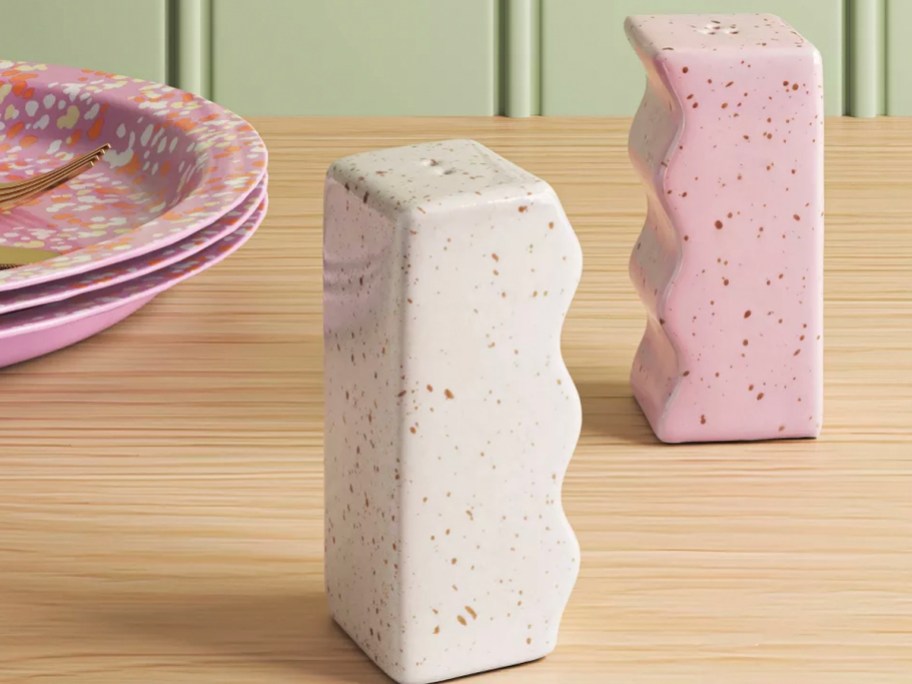 pink and white shakers on table