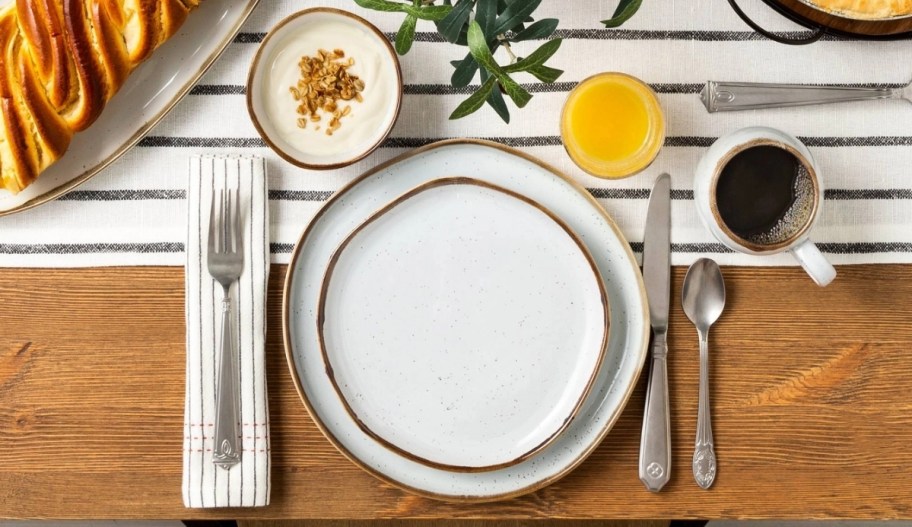 a dinner place setting with cream colored salad plate