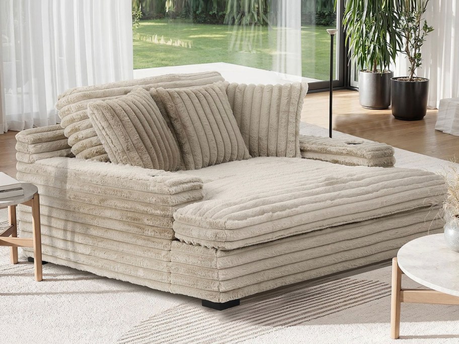 oversized tan chaise chair with cup holders in living room