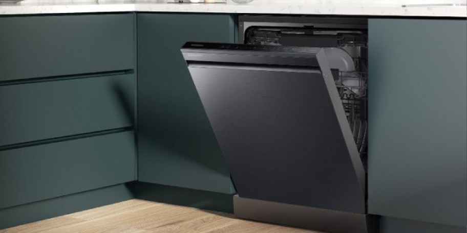 stainless steel dishwasher in kitchen with green cabinets