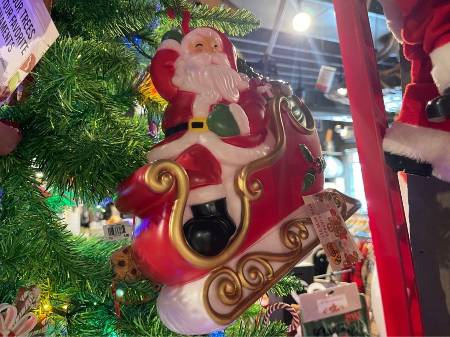 a santa blowmold ornament on a christmas tree